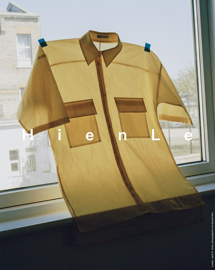 a yellow shirt sitting on top of a window sill