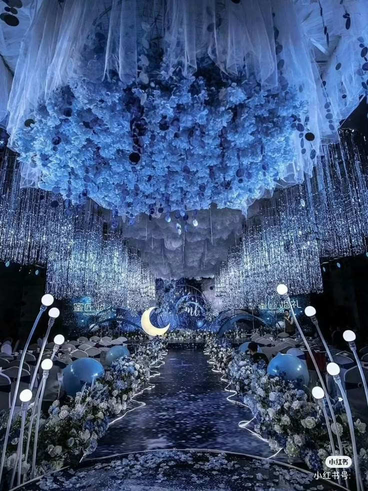 an elaborately decorated room with chandeliers and flowers on the ceiling is lit by blue lights