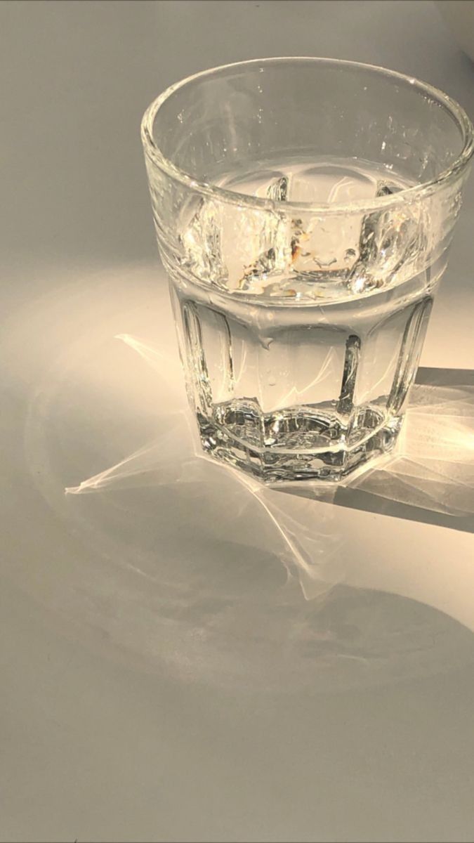 a glass filled with water sitting on top of a table