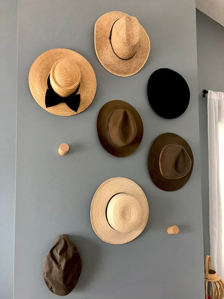 several hats are arranged on the wall in this room