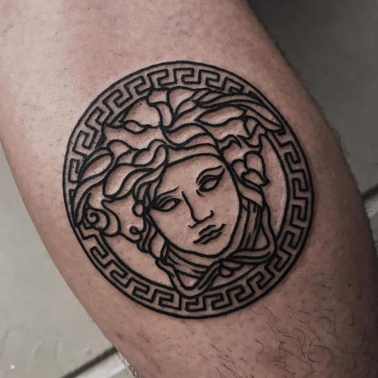 a man's leg with a tattoo on it that has a woman in the center