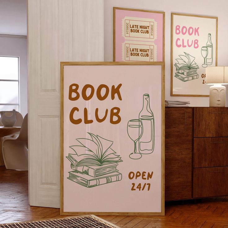 a book club sign sitting on top of a hard wood floor next to a wooden dresser