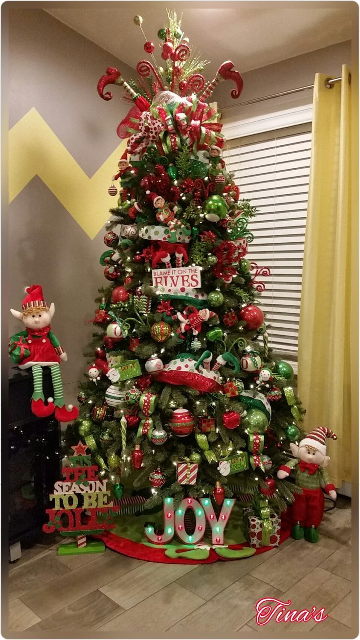 a decorated christmas tree in the corner of a room