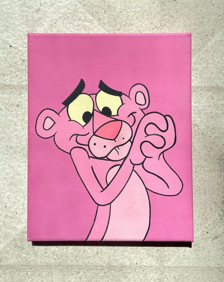 a pink square painting with a cartoon character on it's face and hands in the shape of a heart