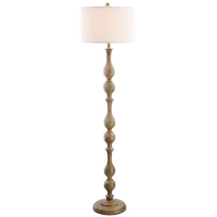 a wooden floor lamp with a white shade