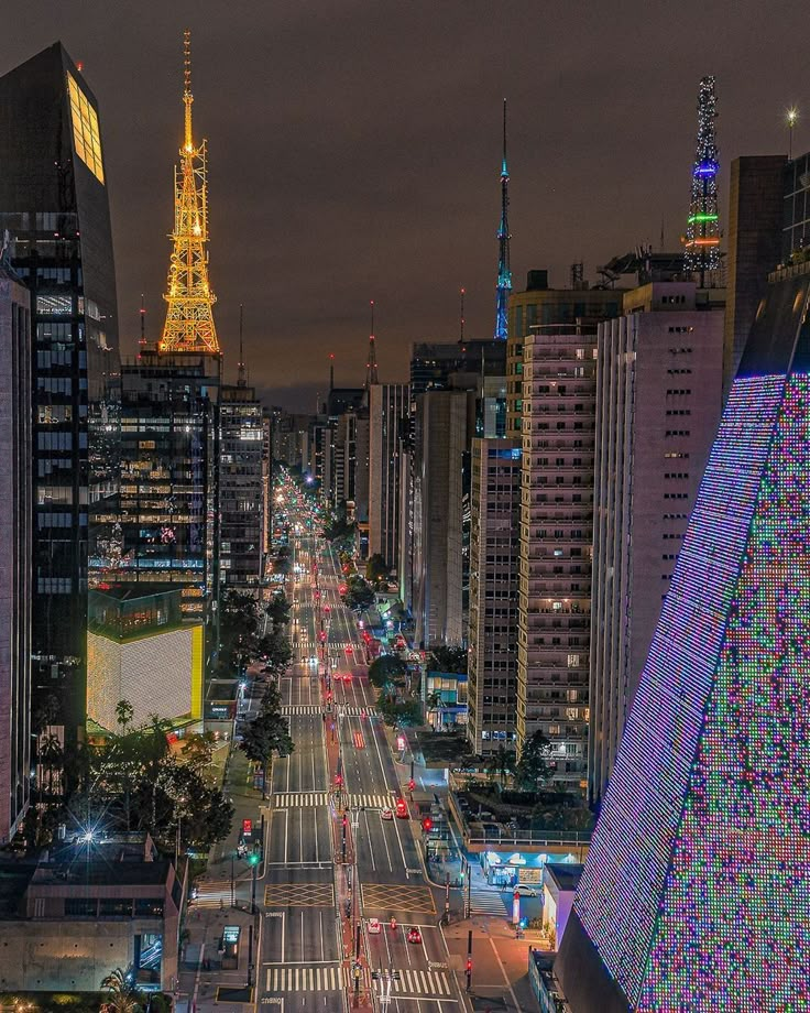 an aerial view of a city at night with the eiffel tower in the background