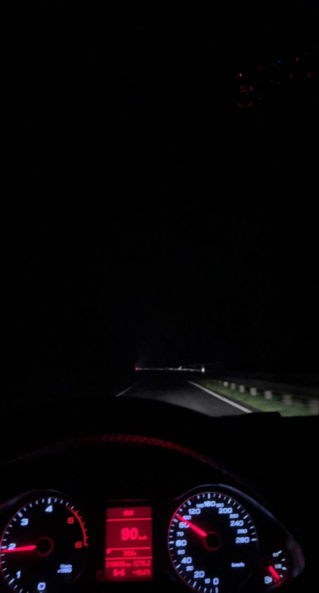 the dashboard of a car at night time