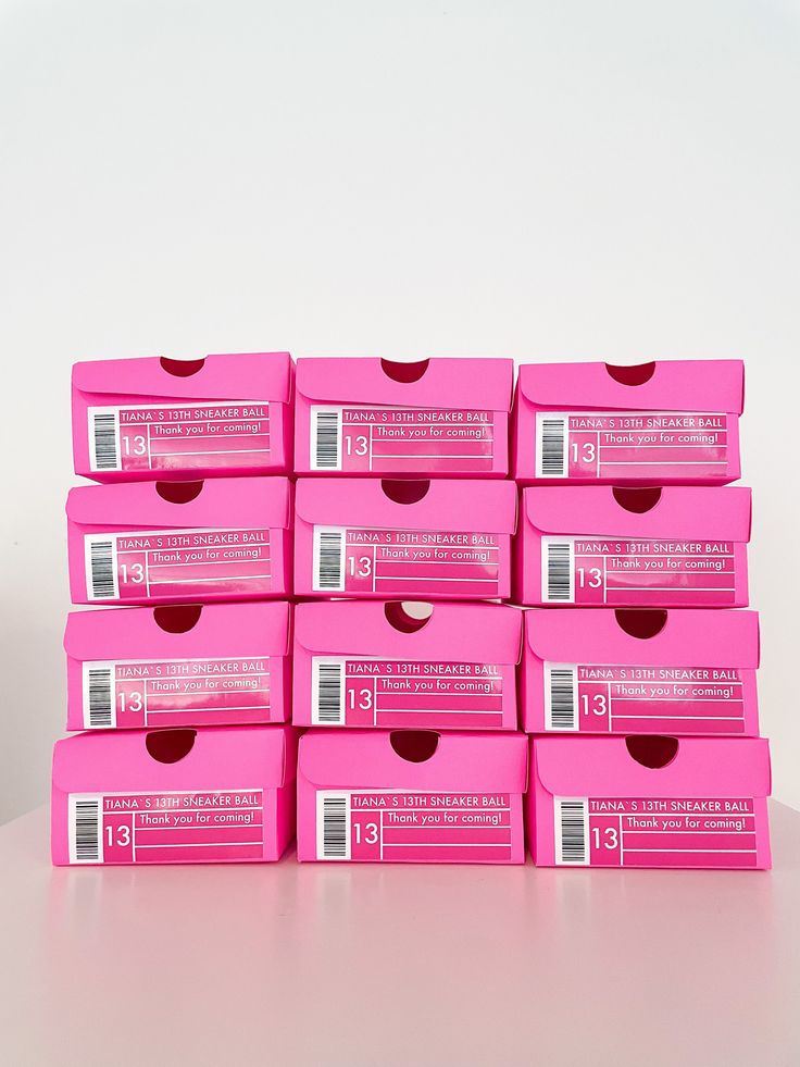 many pink boxes stacked on top of each other