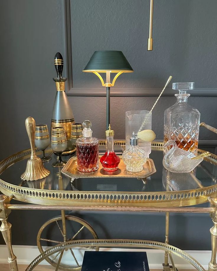 a glass table topped with bottles and glasses