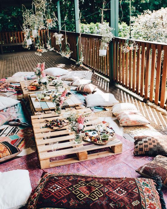 a wooden table with lots of pillows on top of it