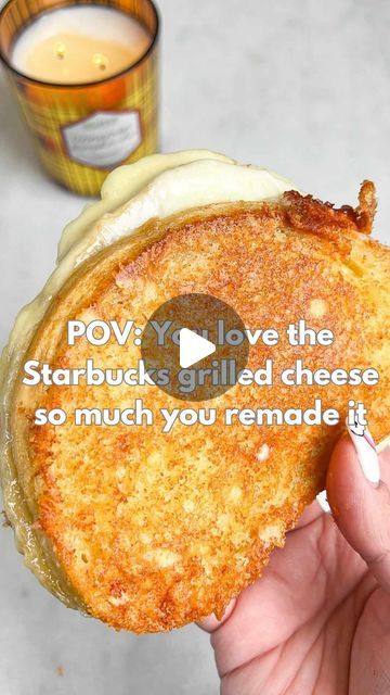 a person holding up a sandwich with the caption pov you love the starbuck grilled cheese so much you remage it