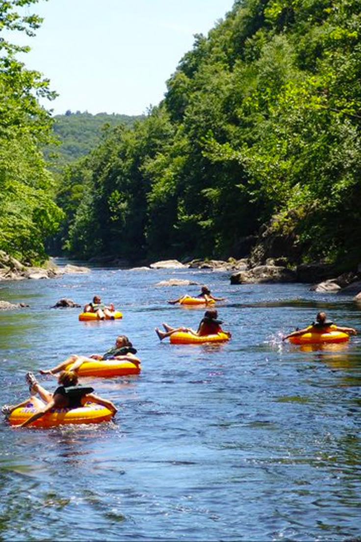 several people on rafts floating down a river