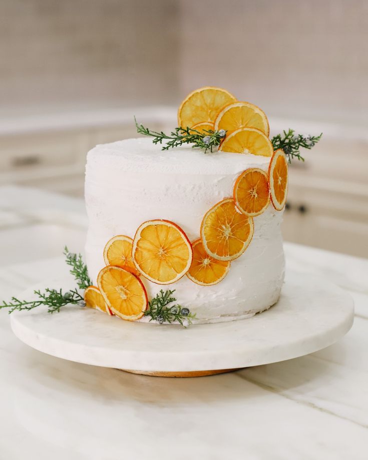 a white cake with orange slices on it