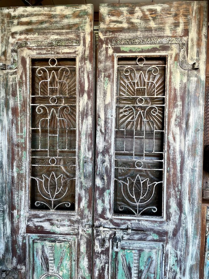 an old wooden door with wrought iron bars