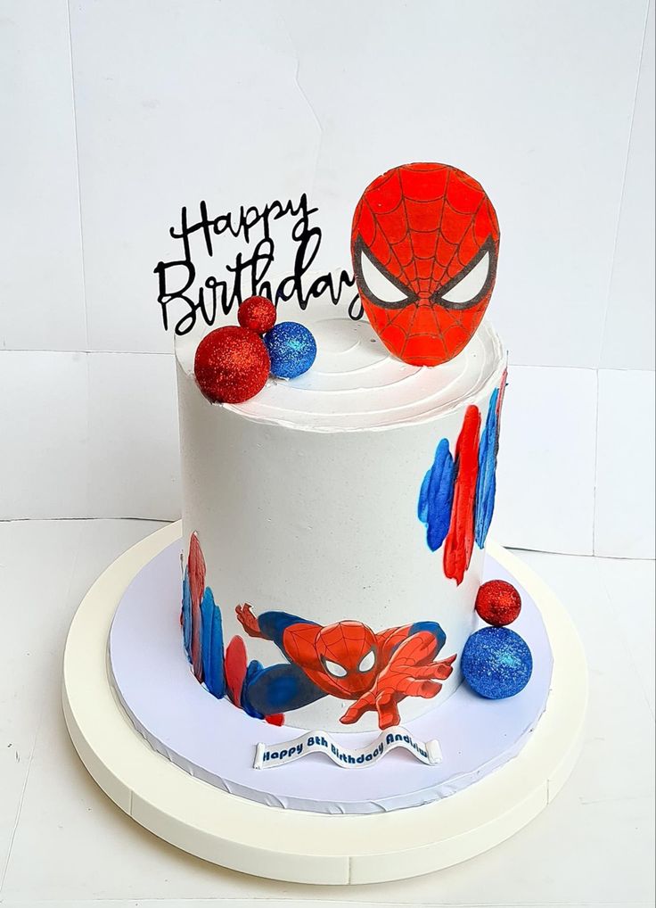 a spiderman birthday cake on a white plate