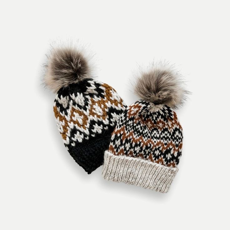 two knitted hats with pom - poms on the top, one brown and white