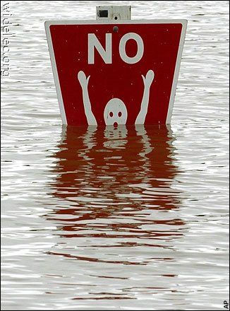 a red and white sign that is in the water