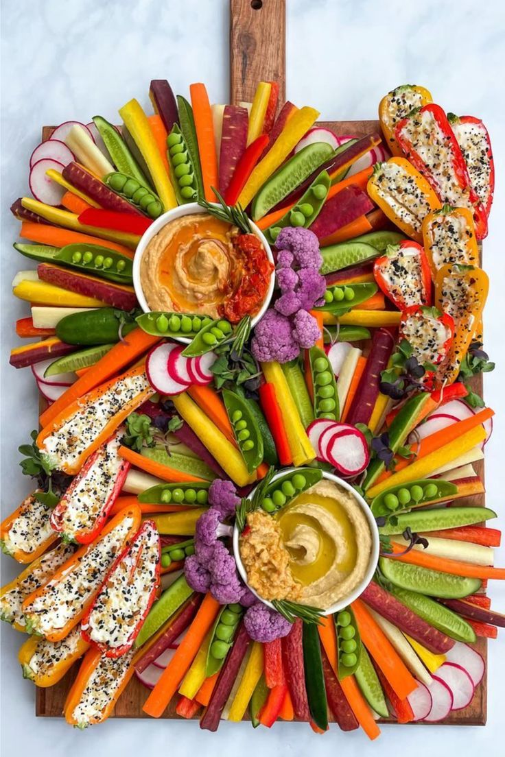 a platter with carrots, celery, radishes and other vegetables