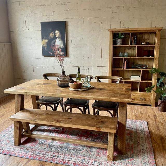 a wooden table and bench in a room