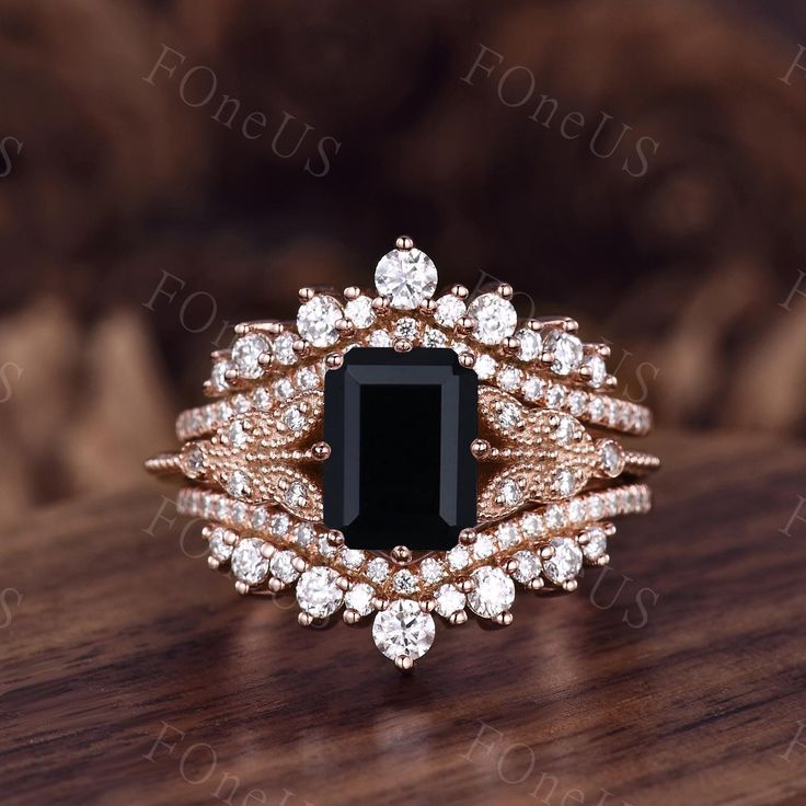 a black and white diamond ring sitting on top of a wooden table