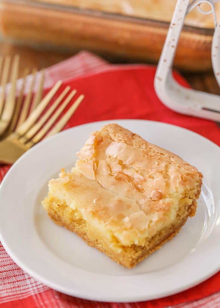 a piece of cake sitting on top of a white plate next to a knife and fork