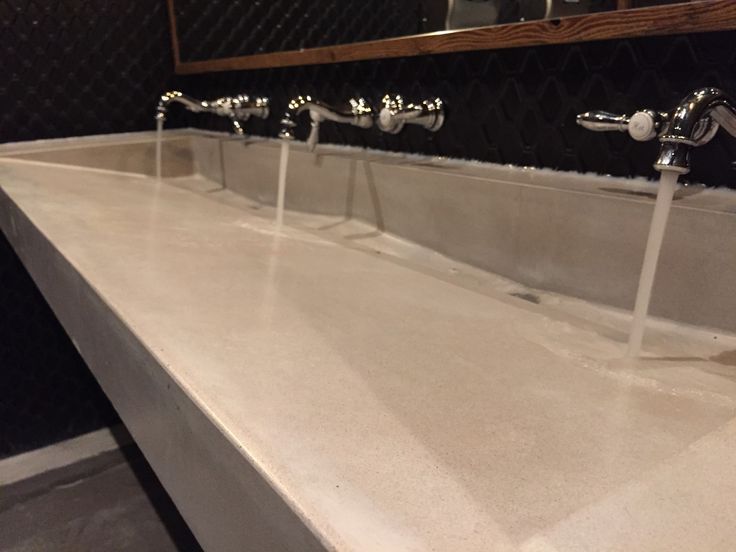 three faucets are lined up on the counter top