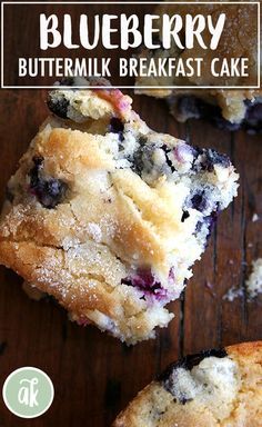 blueberry breakfast cake is cut in half on a wooden table