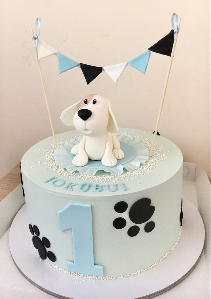 a birthday cake with a dog on top