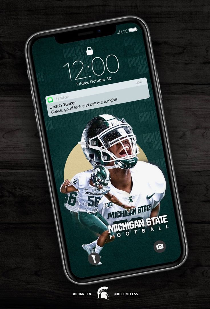 the michigan state football app is displayed on an iphone's screen, which features a photo of michael state running back to his team