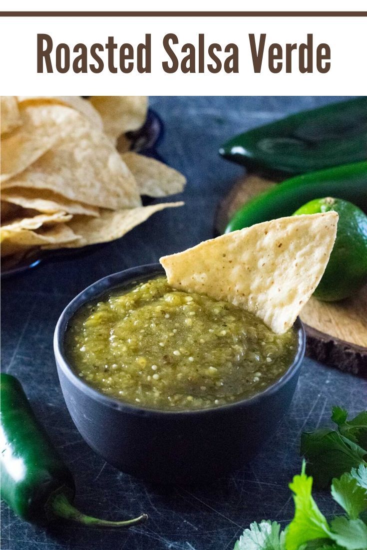 a black bowl filled with salsa next to tortilla chips