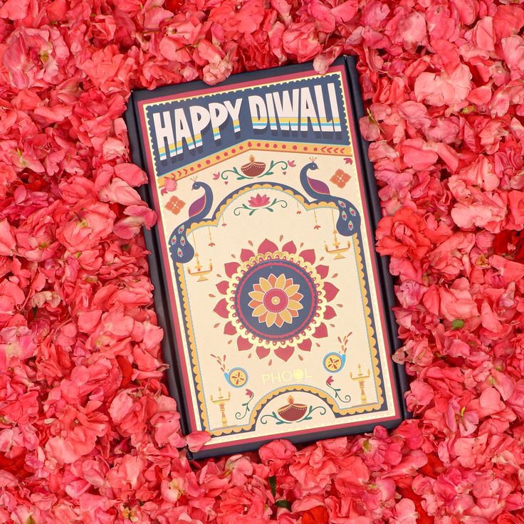 a happy diwal sign surrounded by red flowers