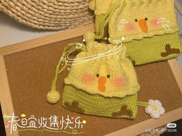 two crocheted bags sitting on top of a table