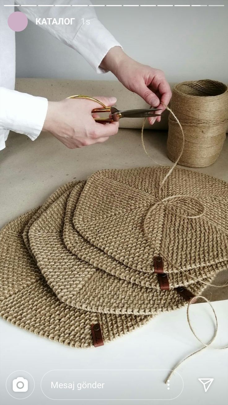 someone is making some kind of placemats out of jute