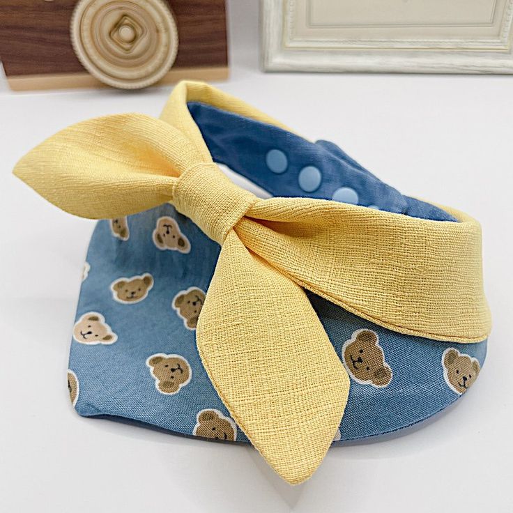 a pair of shoes with a yellow bow on the front and blue bottom, sitting on a table