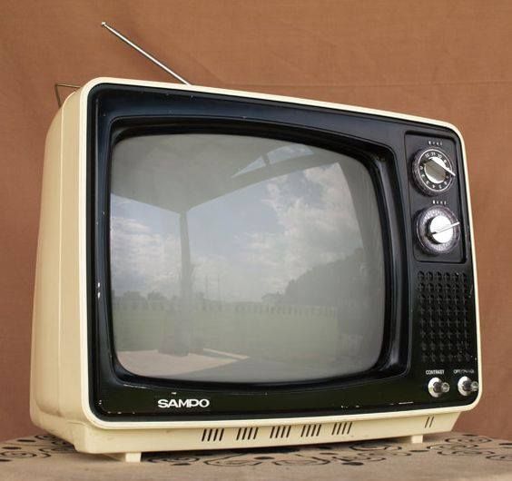 an old tv sitting on top of a table