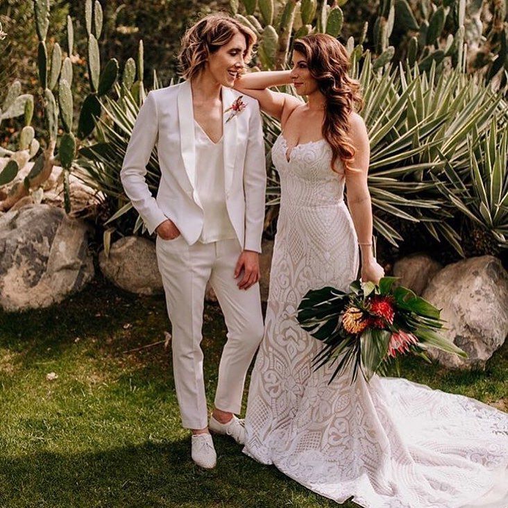 a bride and groom standing in front of cacti at their wedding day,