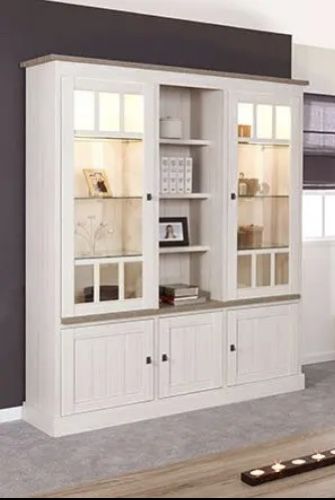 a large white bookcase with glass doors and shelves in the middle of a room