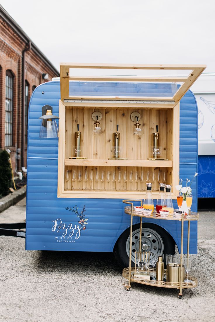 a small blue trailer with drinks in it