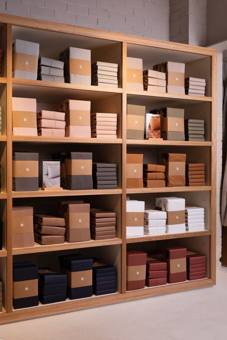 a large book shelf filled with lots of books and boxes on top of each other