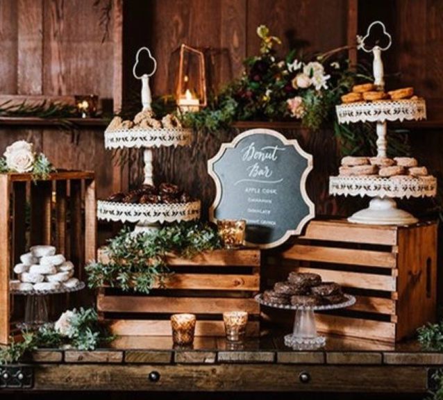 an assortment of desserts and pastries on display in front of a chalkboard sign