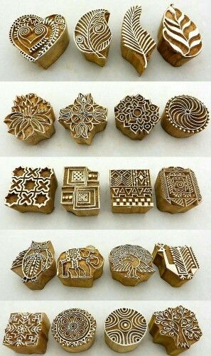 several different shapes and sizes of carved wooden stamps with designs on the front, back and sides