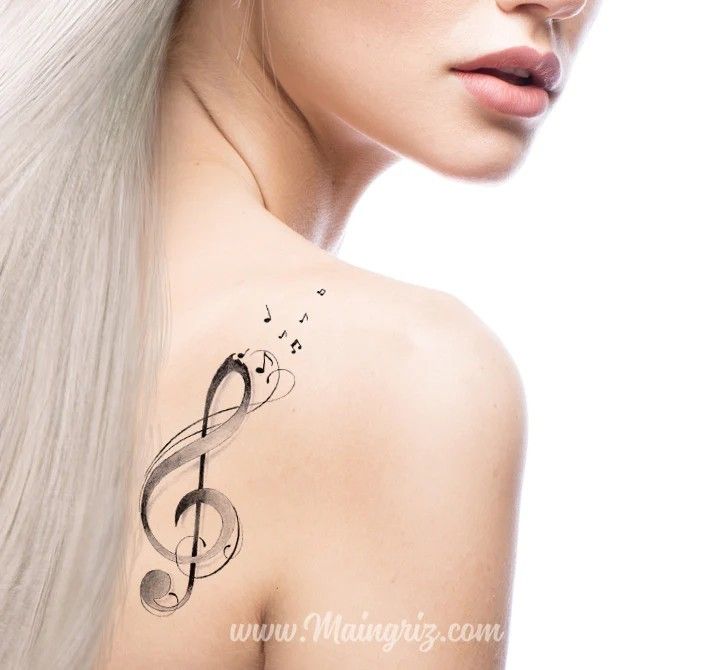 a woman with long white hair has musical notes on her shoulder and behind her ear