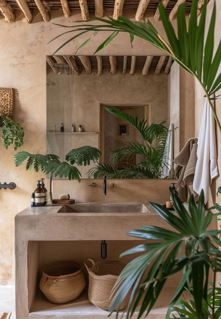 a bathroom with a sink and potted plants