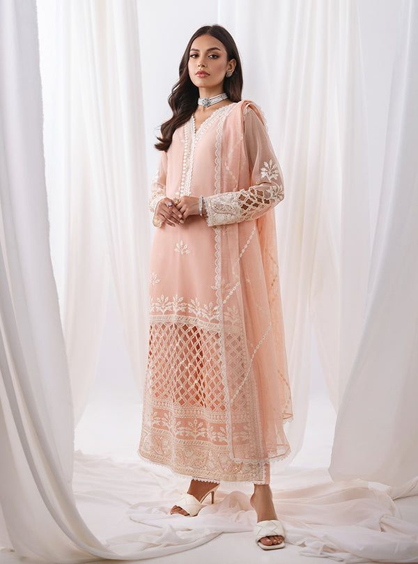 Defining our mesmerizing peach ensemble, which carries you to another dimension of ethereal beauty. Your look effortlessly refines everywhere you go, owing the exquisite cut work on the front of the apparel, which is meticulously crafted with threads, sequence jaal and pattern to add a touch of glamour and refinement. The coordinated pants also feature matching handwork, and the net dupatta is adorned with white embroidery that perfectly contrasts with your apparel. Embrace the romance of summer Zainab Chottani, Sana Safinaz, Another Dimension, Maria B, Net Dupatta, Ethereal Beauty, Gold Threads, White Embroidery, Cut Work