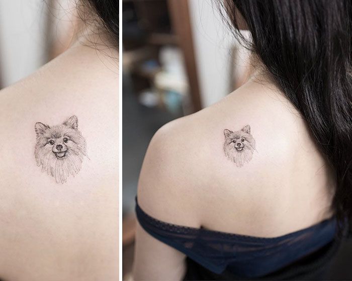 a woman with a small dog tattoo on her back