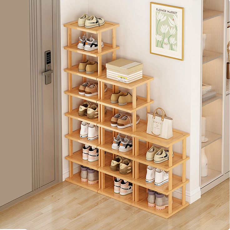 there is a shelf with many pairs of shoes on it in the corner next to a door