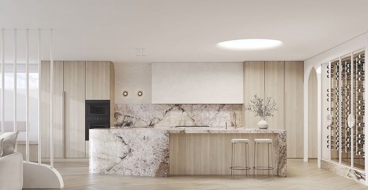 a large kitchen with marble counter tops and white walls, along with wooden flooring