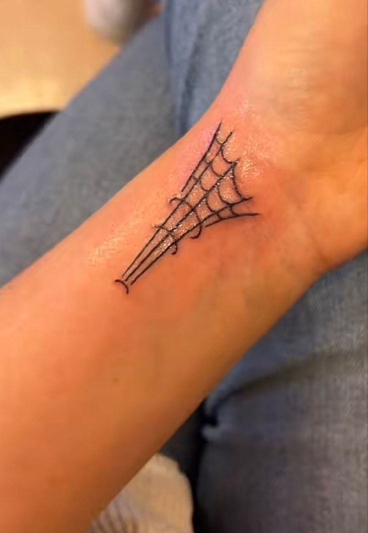 a person with a spider web tattoo on their arm