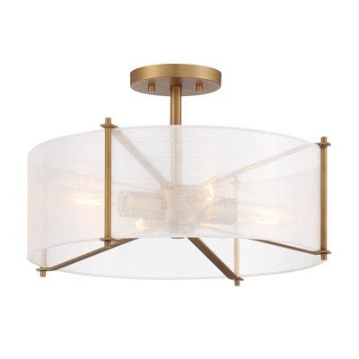 a semi - flush ceiling light fixture with white fabric shades on the bottom and gold accents