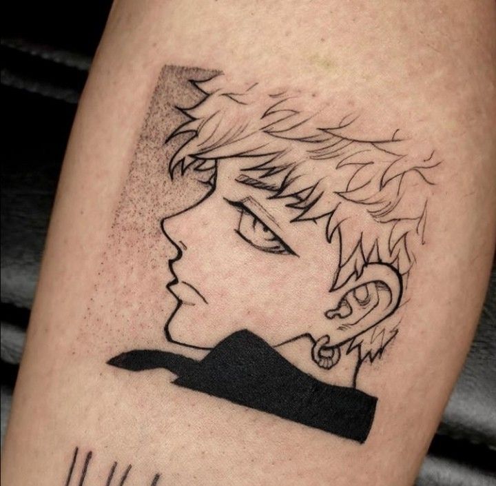 a man's leg with a black and white drawing of a boy on it